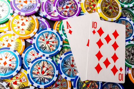poker chips and cards on black background