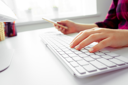 Hands of an office woman typingの写真素材