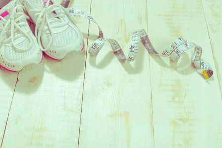 Shoes and sports equipment on wooden floor, top viewの写真素材