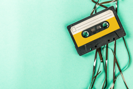 Old audio cassettes on turquoise background