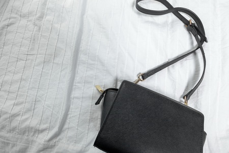 Female bag on white textileの写真素材