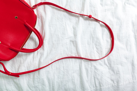 Female bag on white textileの写真素材