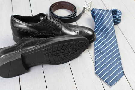 shoes and accessories for men lay on the wooden floorの写真素材