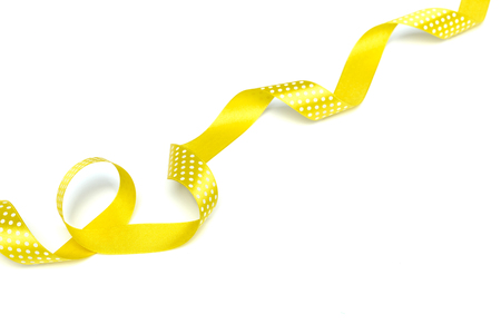 Yellow ribbons isolated on whiteの写真素材