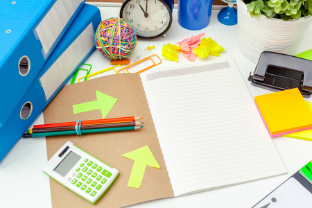 Work place of a creative person with a variety of colorful stationery objects