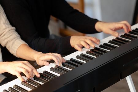 Closeup of hands playing piano. Music and hobby conceptの写真素材