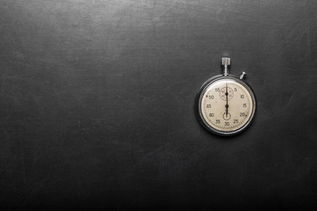 pocket watch on a black tableの写真素材