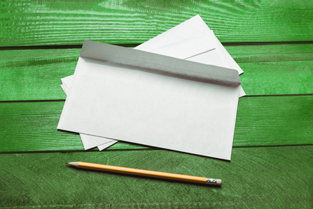 Blank paper, envelope on green wooden table