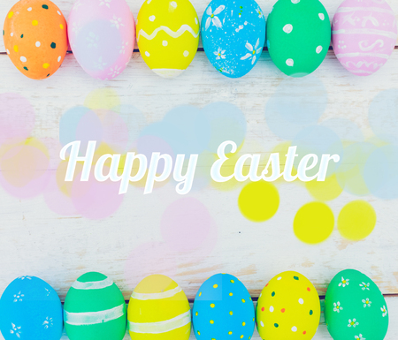 Easter eggs painted in pastel colors on white wooden background.の写真素材