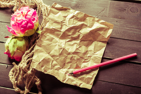 flowers and a notebook on wooden backgroundの写真素材