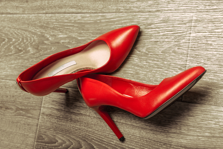 Red women shoes on wooden backgroundの写真素材