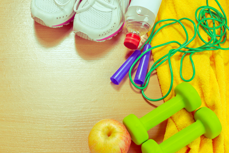 Shoes and sports equipment on wooden floor, top viewの写真素材