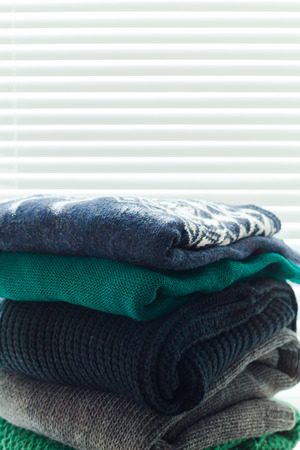 Stack of white cozy knitted sweaters