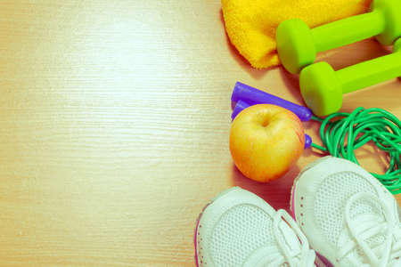 Shoes and sports equipment on wooden floor, top viewの写真素材