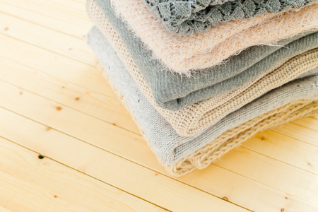Stack of white cozy knitted sweatersの写真素材