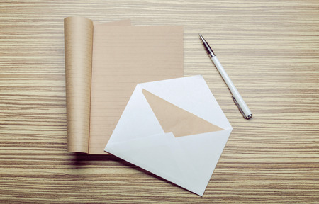 Photo of blank envelope on a  wooden backgroundの写真素材