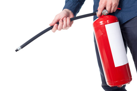 Man using fire extinguisher isolated on whiteの写真素材