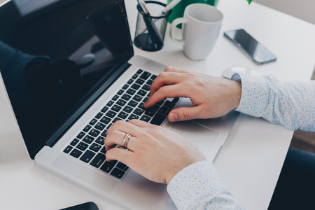 Businessman at work. Close-up top view of man working on laptopの写真素材