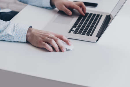 Businessman at work. Close-up top view of man working on laptopの写真素材