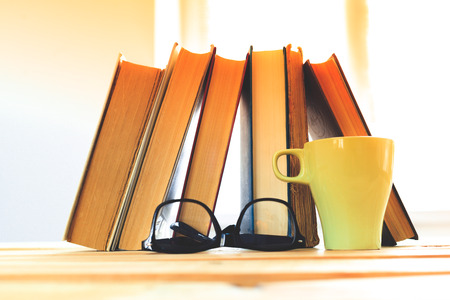 reading glasses with books on the tableの写真素材