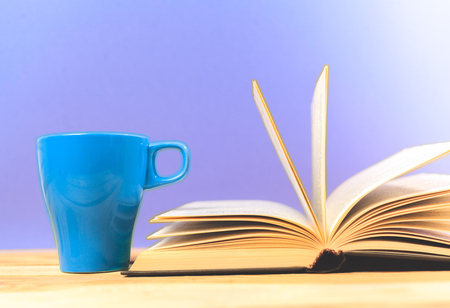 Color cup of tea with books on tableの写真素材