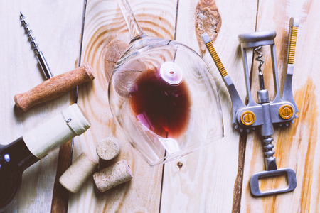 Wine glass, cork and corkscrew over wooden tableの写真素材