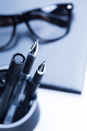 Notebook, pencil and glassesの写真素材