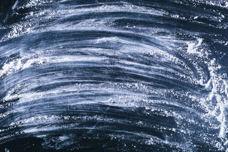 Dark wooden background with flour dustの写真素材