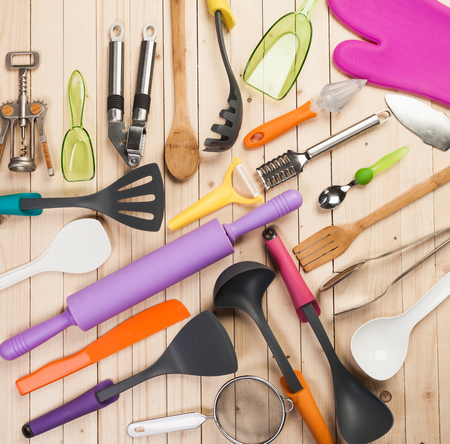 cookware and accessories on a wooden table.の写真素材
