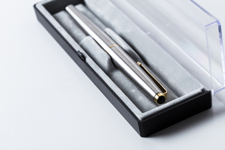 Pen in box on white backgroundの写真素材