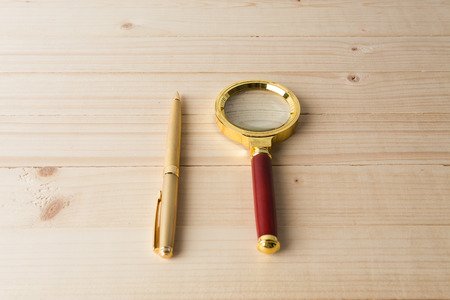 magnifying glass  on wooden tableの写真素材
