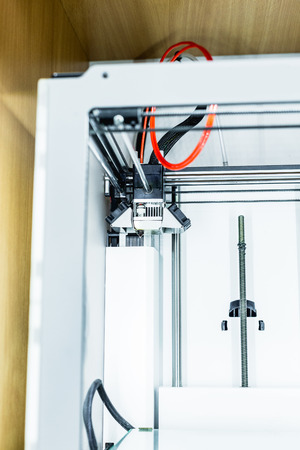 3d printer with bright red filament.