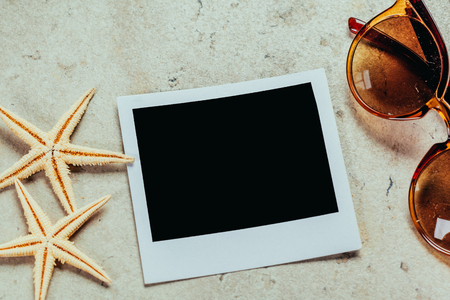Nautical background with retro sunglasses and empty photos frames, sea shellsの写真素材