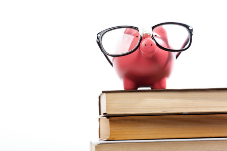 piggy bank on a stack of book concept of education costsの写真素材