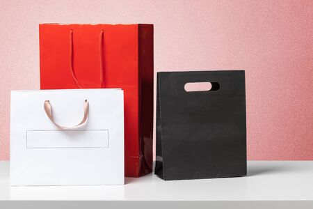 few different shopping bags on the deskの写真素材