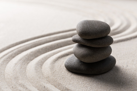 zen stone garden round stone and raked sandの写真素材