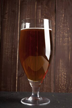 Lager beer in glass and potato chips on wooden backgroundの写真素材