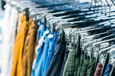 Different clothes on hangers close upの写真素材