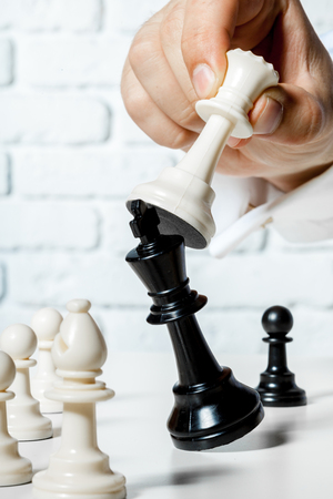 Hand of businessman playing chessの写真素材