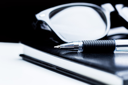 Notebook, pencil and glassesの写真素材
