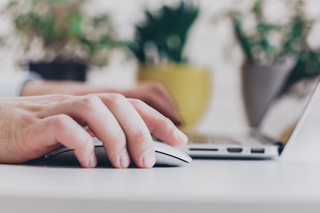 Businessman at work. Close-up top view of man working on laptopの写真素材