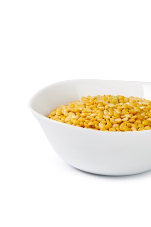 Dry yellow split peas isolated on white.の写真素材