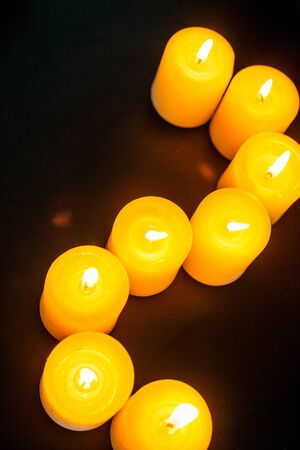 closeup to burning candles in darknessの写真素材