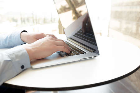 Caucasian man using laptop at tableの写真素材