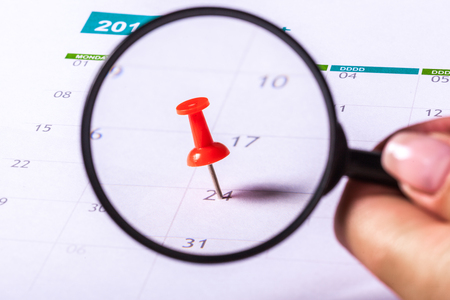 Concept image of a calendar with red push pinの写真素材