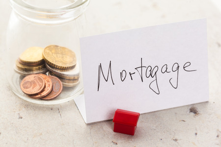 Mortgage concept by model house with coinsの写真素材