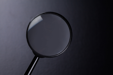 magnifying glass on dark backgroundの写真素材