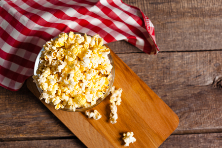 A bowl of popcorn on tableclothの写真素材
