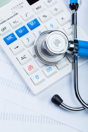 Health care costs. Stethoscope and calculatorの写真素材