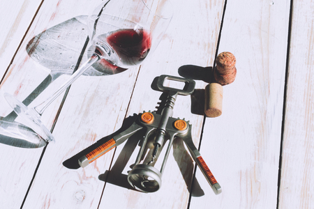 Wine glass, cork and corkscrew over wooden tableの写真素材